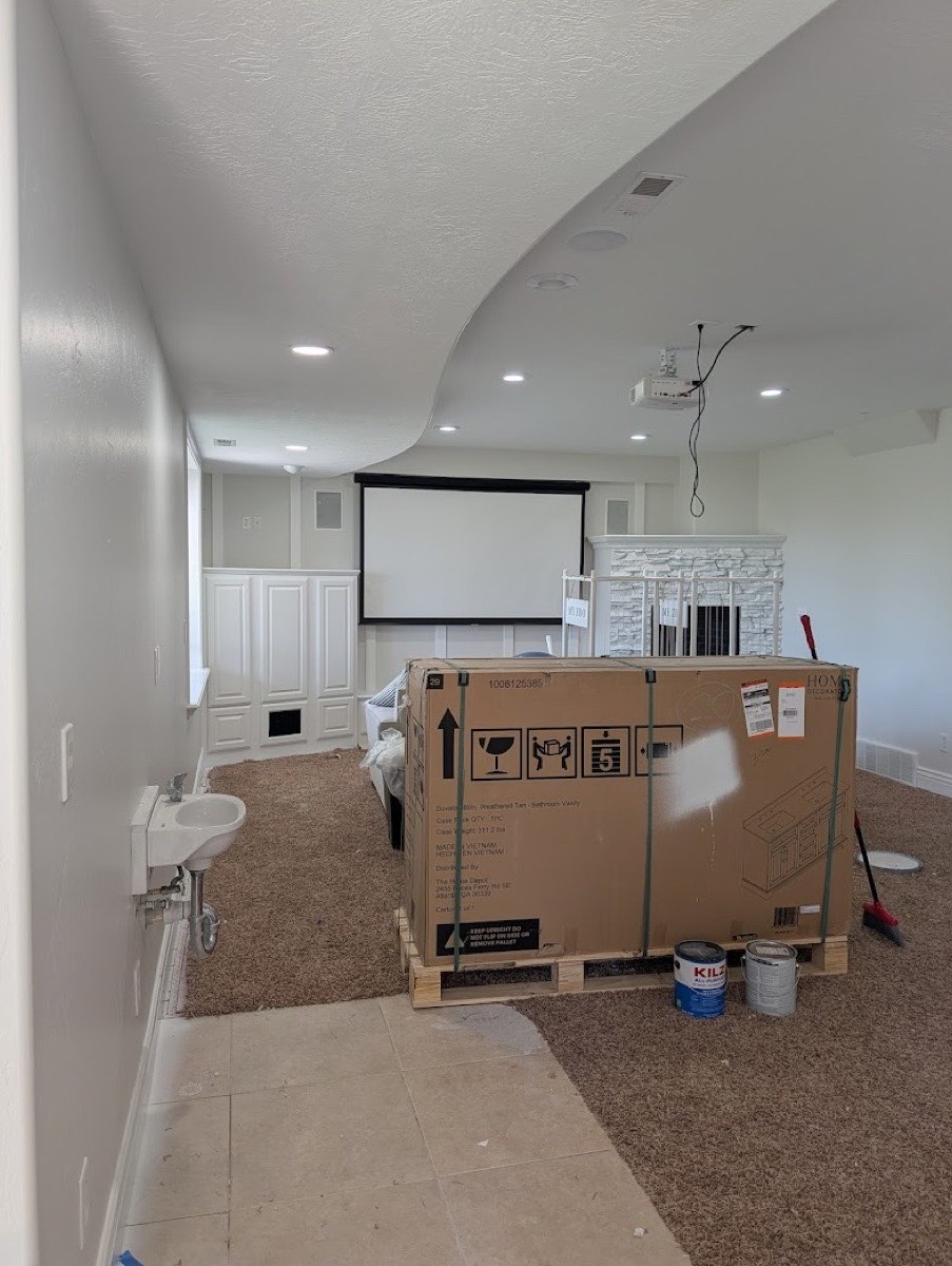 Basement remodel in progress — white wainscoting and trim work being prepped for finish coats