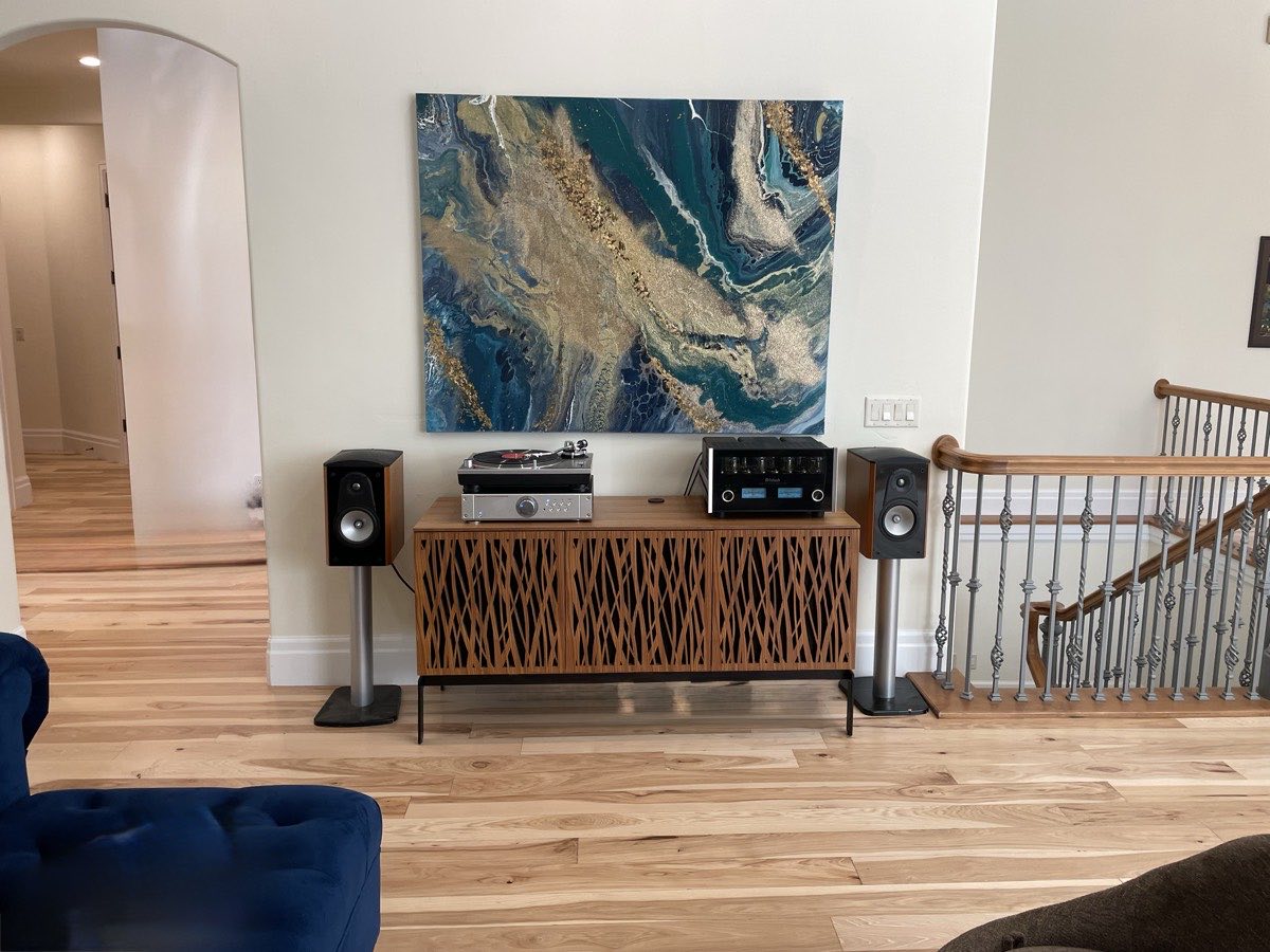 Bright finished living room with smooth white walls, hardwood floor, and a custom audio cabinet — interior painting project in Utah